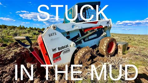 pull bobcat skid steer out of mud|bob cat kubota stuck in mud.